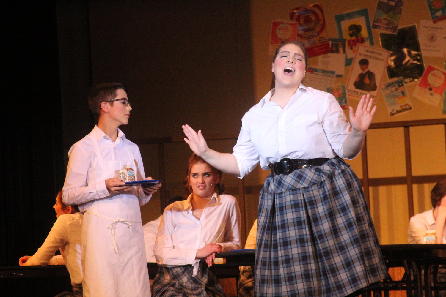 Harriet (Essie Martin) sings to her crush, Martin (Kelby Gingerich), while Emma looks on with disapproval.