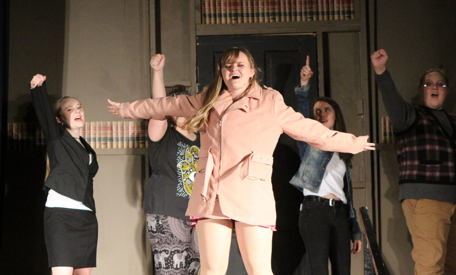 Elle (Nicole Mickelson) sings along with her Harvard Law School classmates during Highland High School's presentation of Legally Blonde – The Musical.