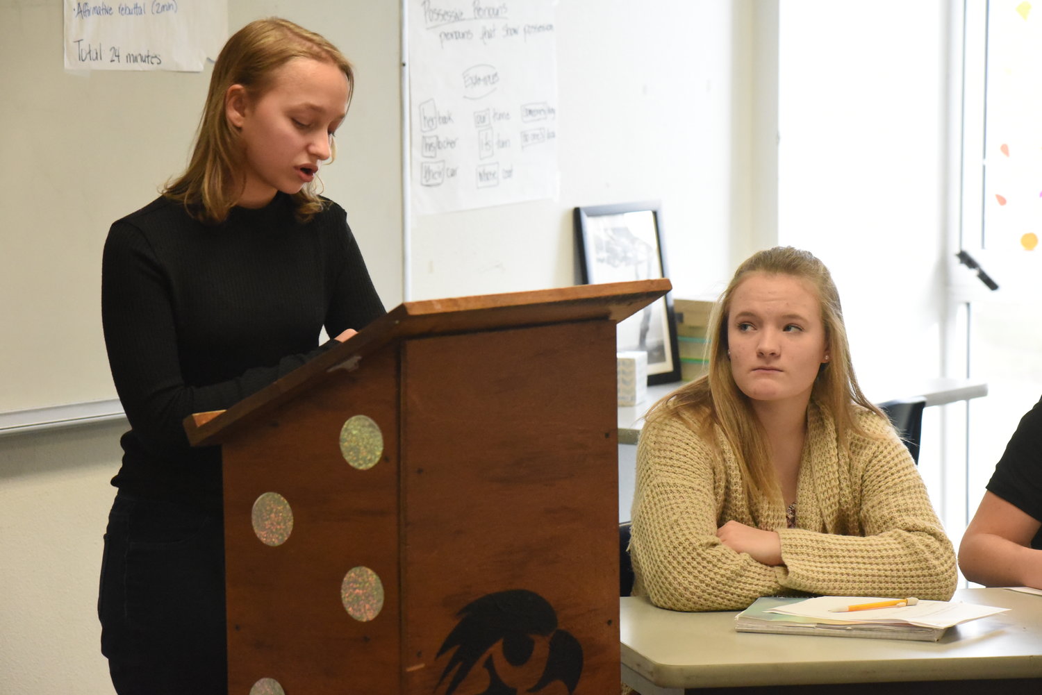 Abby Pierson (right) listens to Kaylee Schmid give her argument on why cellphones should be allowed at Highland.