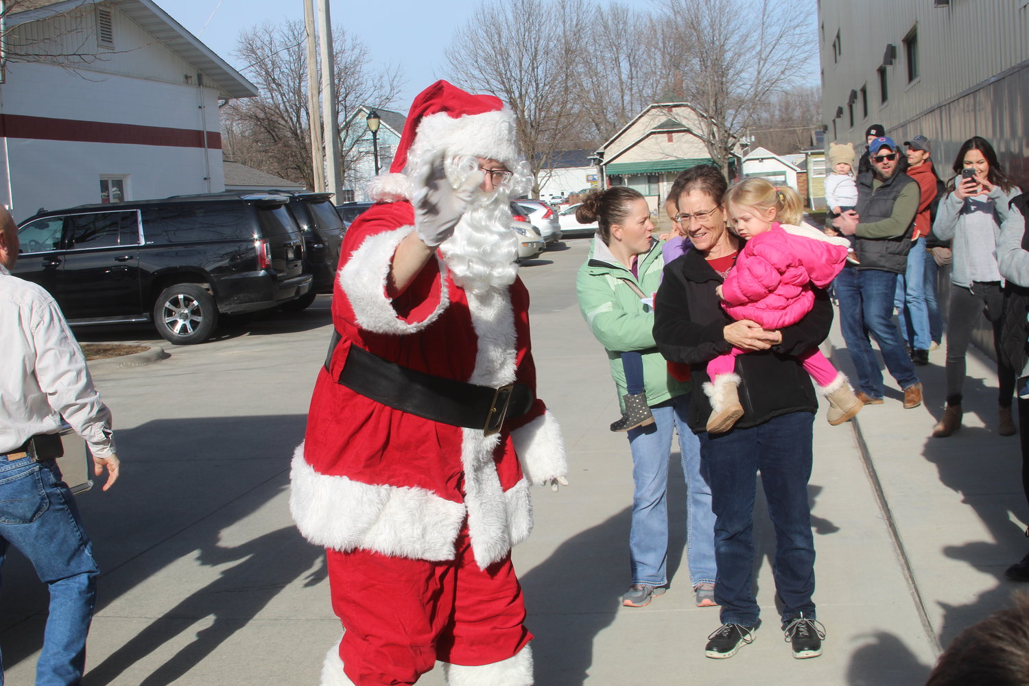 Kneumann Redlinger seems to be fascinated with Santa Claus at Christmas in Kalona on Saturday.