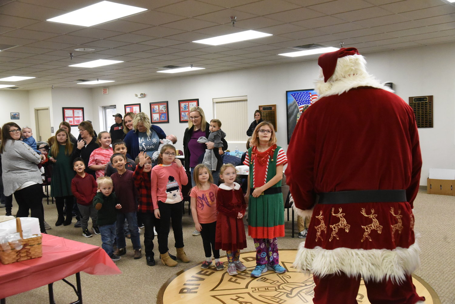 Children lined up to see Santa at the Riverside fire station on Dec. 14.