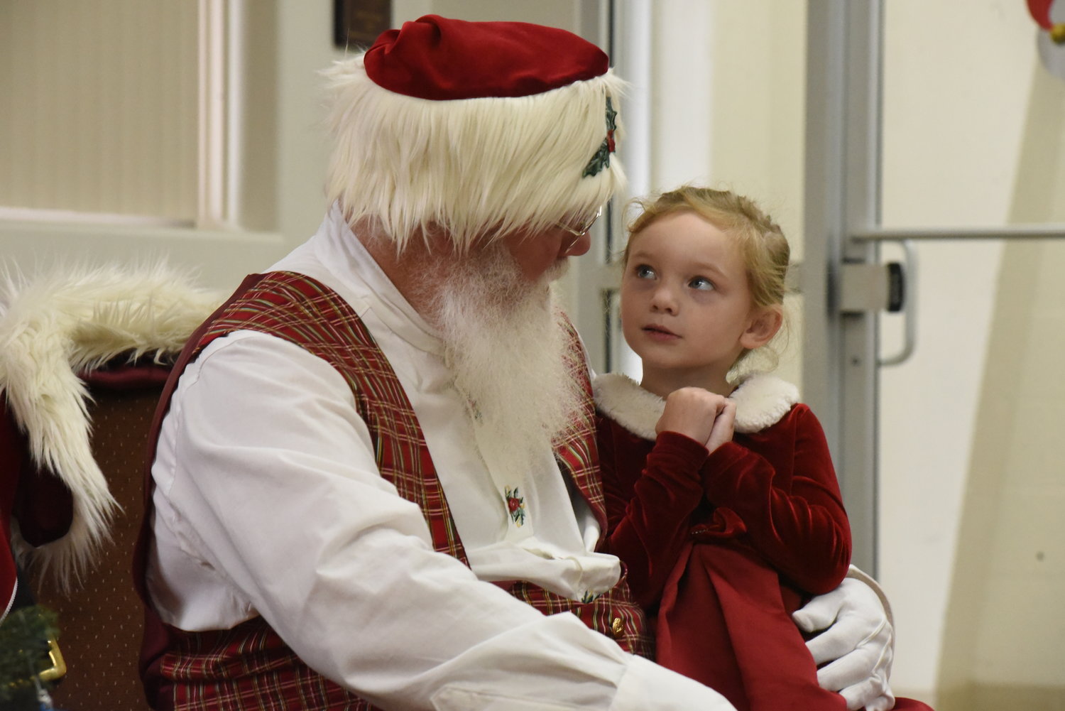 Five-year-old Maleya Knight tells Santa what is on her wish list for Christmas at the Riverside fire station Dec. 14.