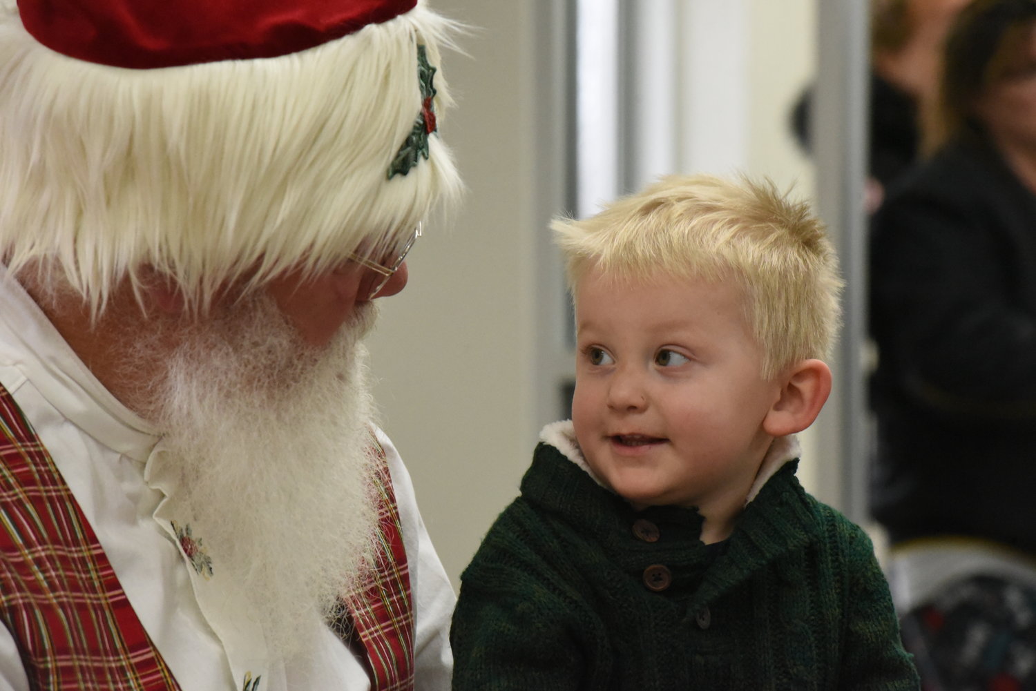 Two-year-old Rhett Schneider talks with Santa at the Riverside fire station on Dec. 14.