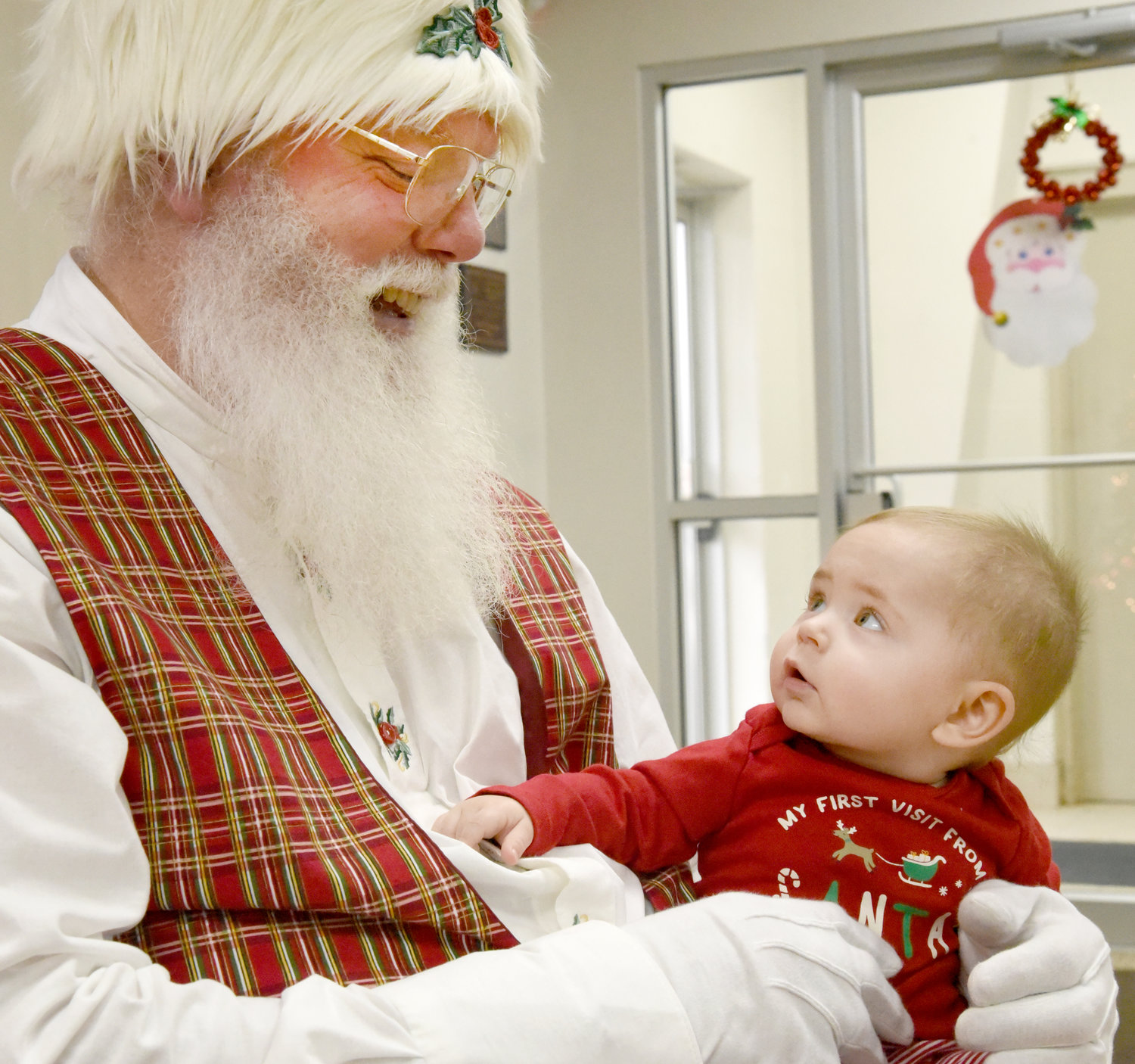 Santa fascinated 7-month-old Bo Redlinger when the baby had his first visit with the jolly old man on Dec. 14 at the Riverside fire station. Dozens of kids took their turn sitting on Santa’s lap while their parents could buy Christmas cookies sold by Trinity United Methodist Church.