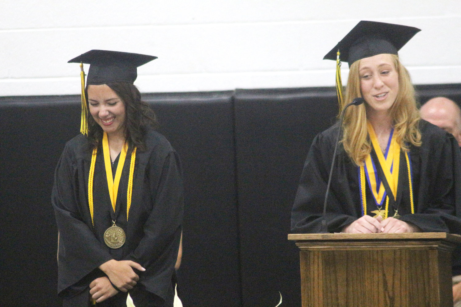 Lone Tree High School seniors Whitney Willoz (left) and Natalie Patterson speak during Sunday’s commencement ceremony.