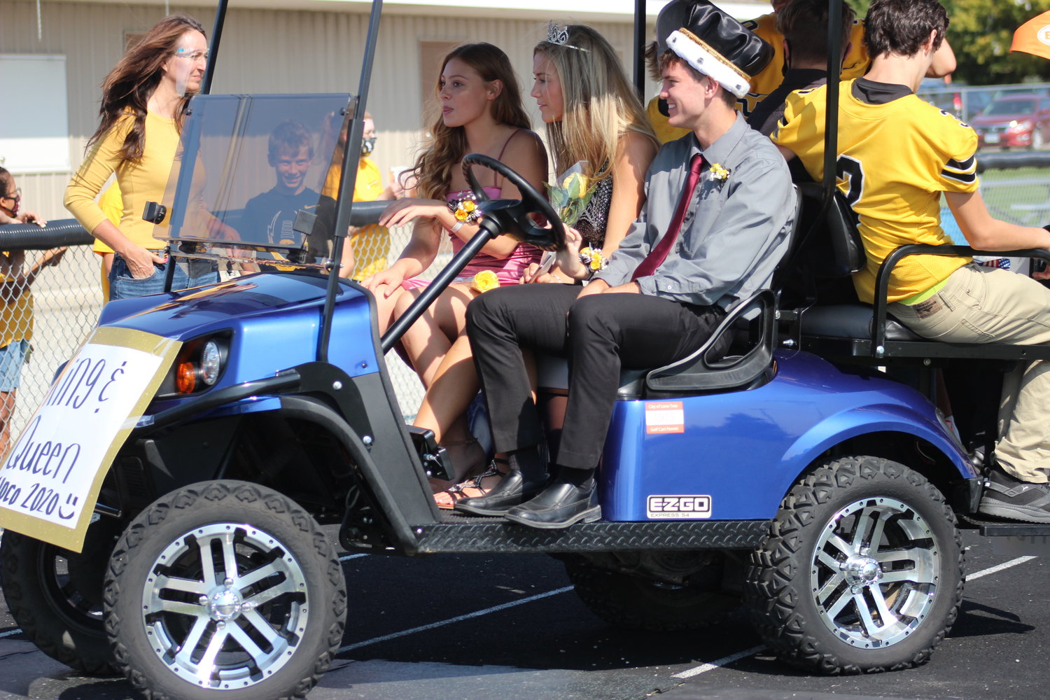 From left to right, Madeline Jacque, Josie Mullinnix, and Alex Viner ride off the football field after the homecoming assembly.