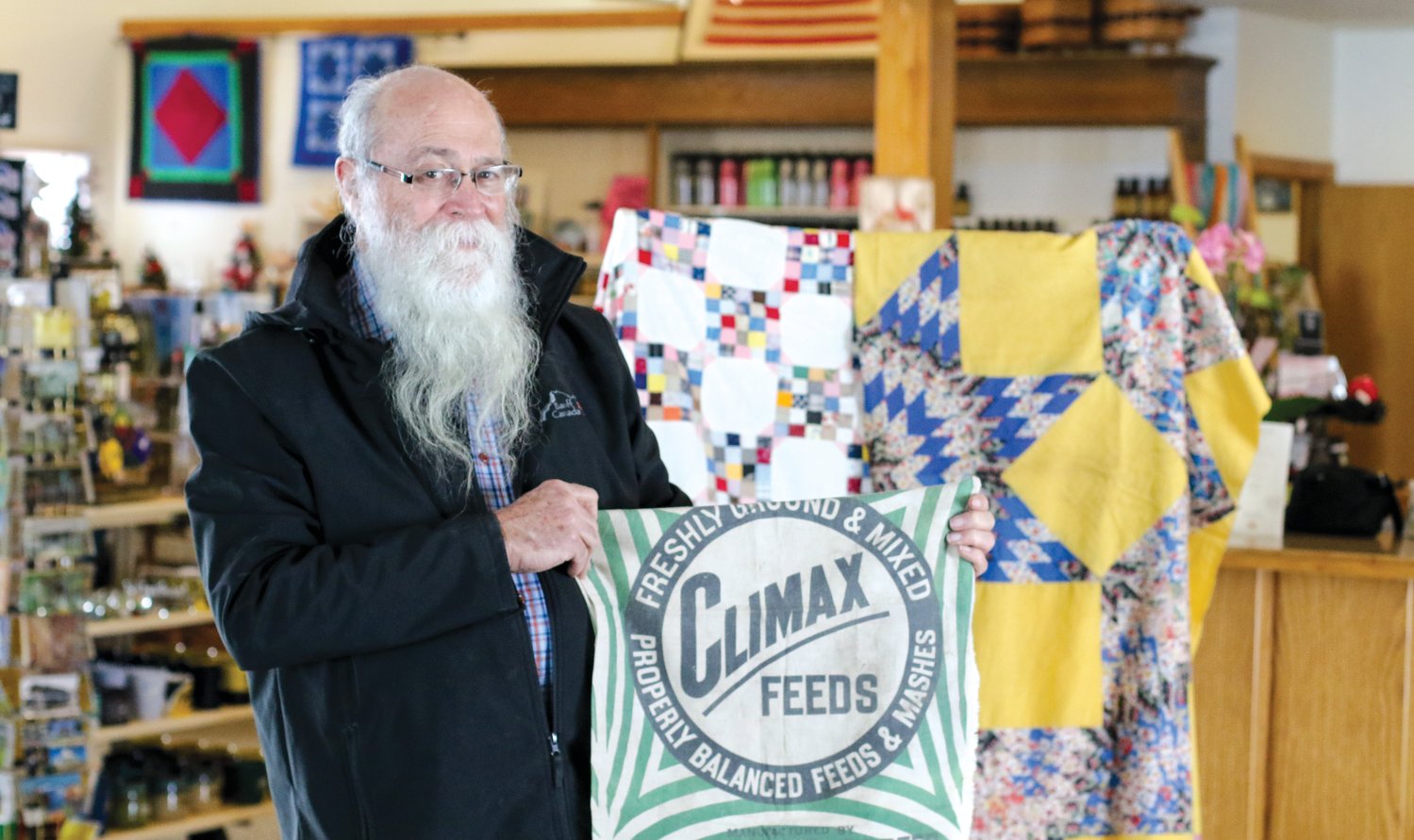 Mike Zahs with his feed sack quilts.