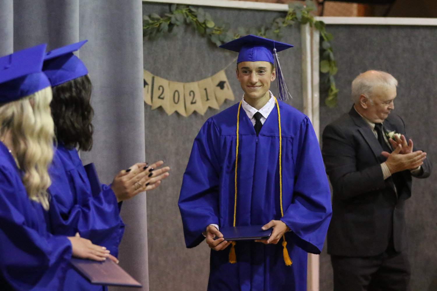 Jamison Stutzman walks across the stage with his diploma during Pathway Christian School's graduation ceremony on May 16, 2021.