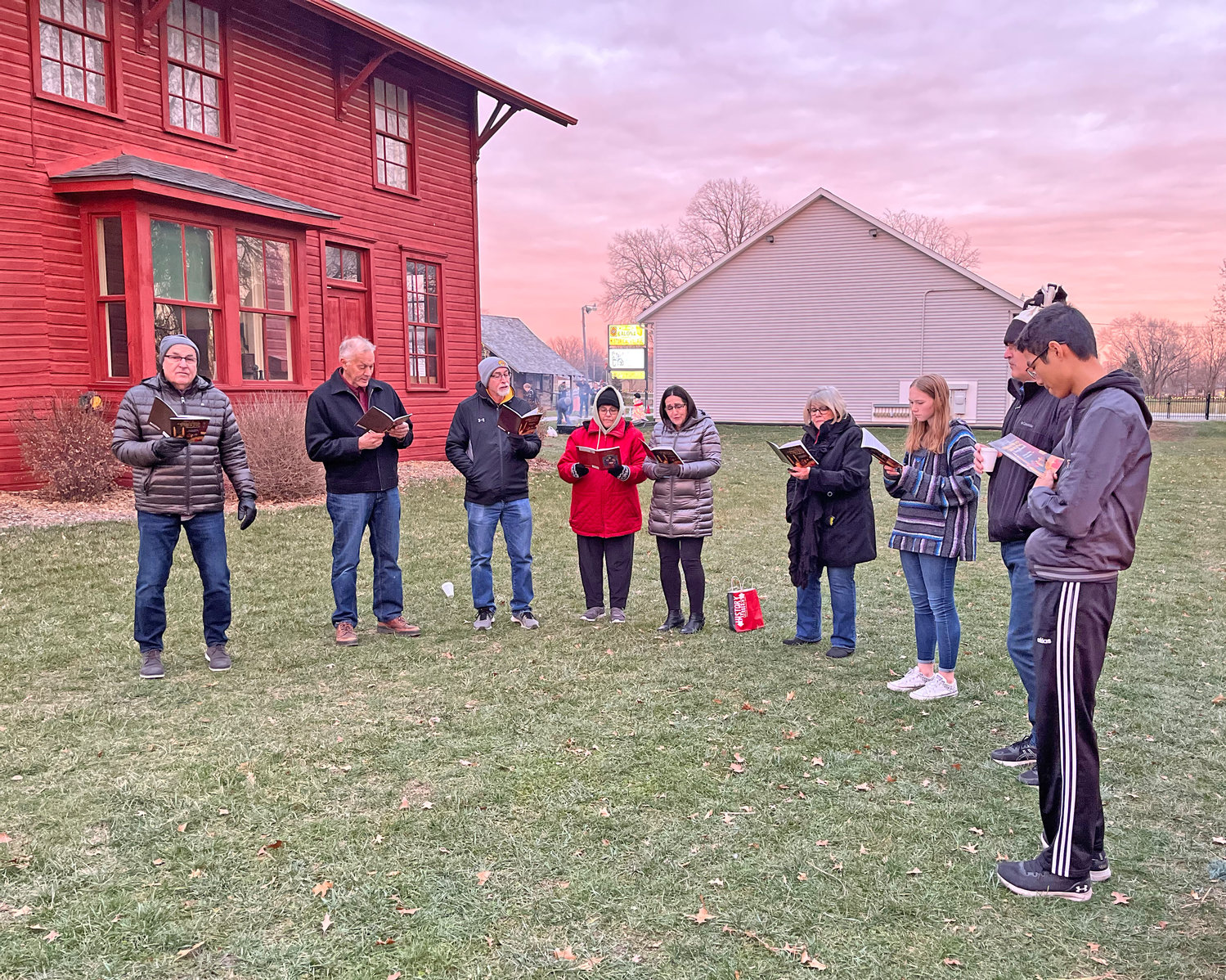 Hillcrest Academy carolers serenade visitors on the grounds of the Kalona Historical Village.