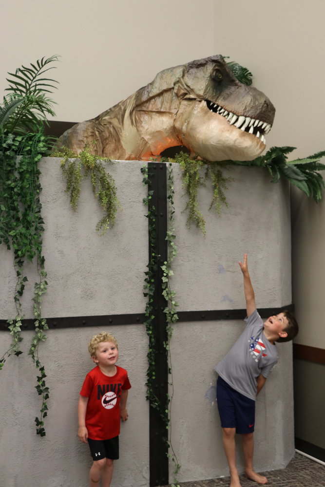 Kids enjoyed the animatronic T-rex at Dino-Ventures in the Wellman Parkside Activities Center.