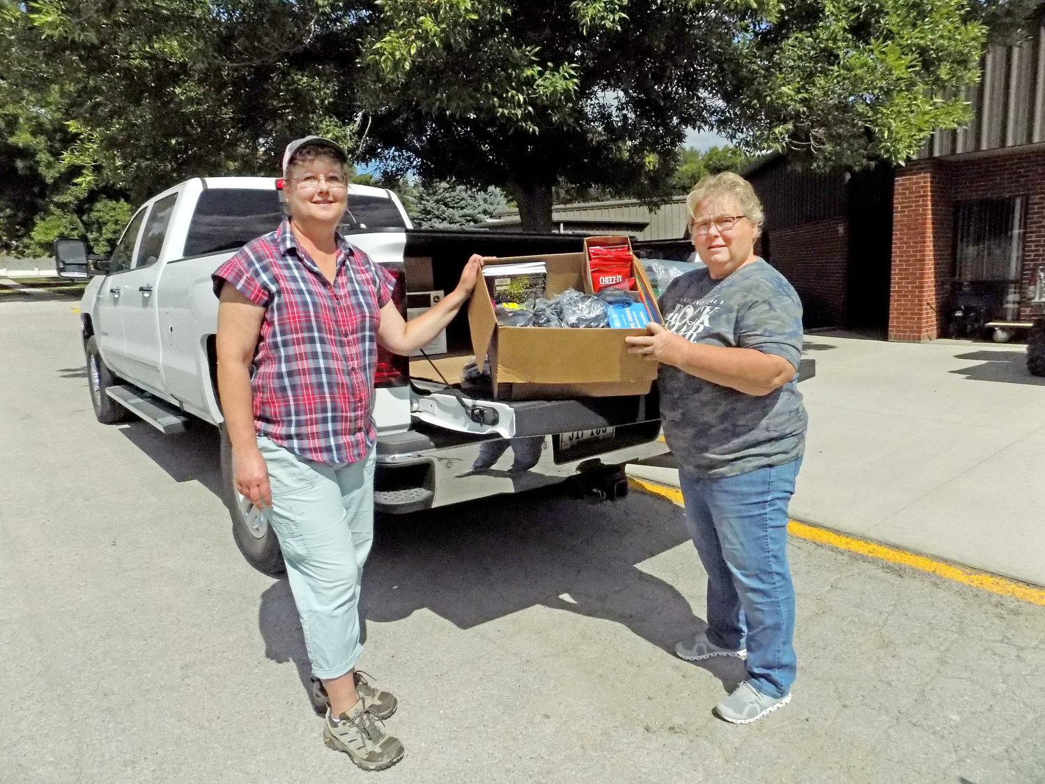 Wendy Boyse and Marilyn Anderson deliver school supplies to area schools.