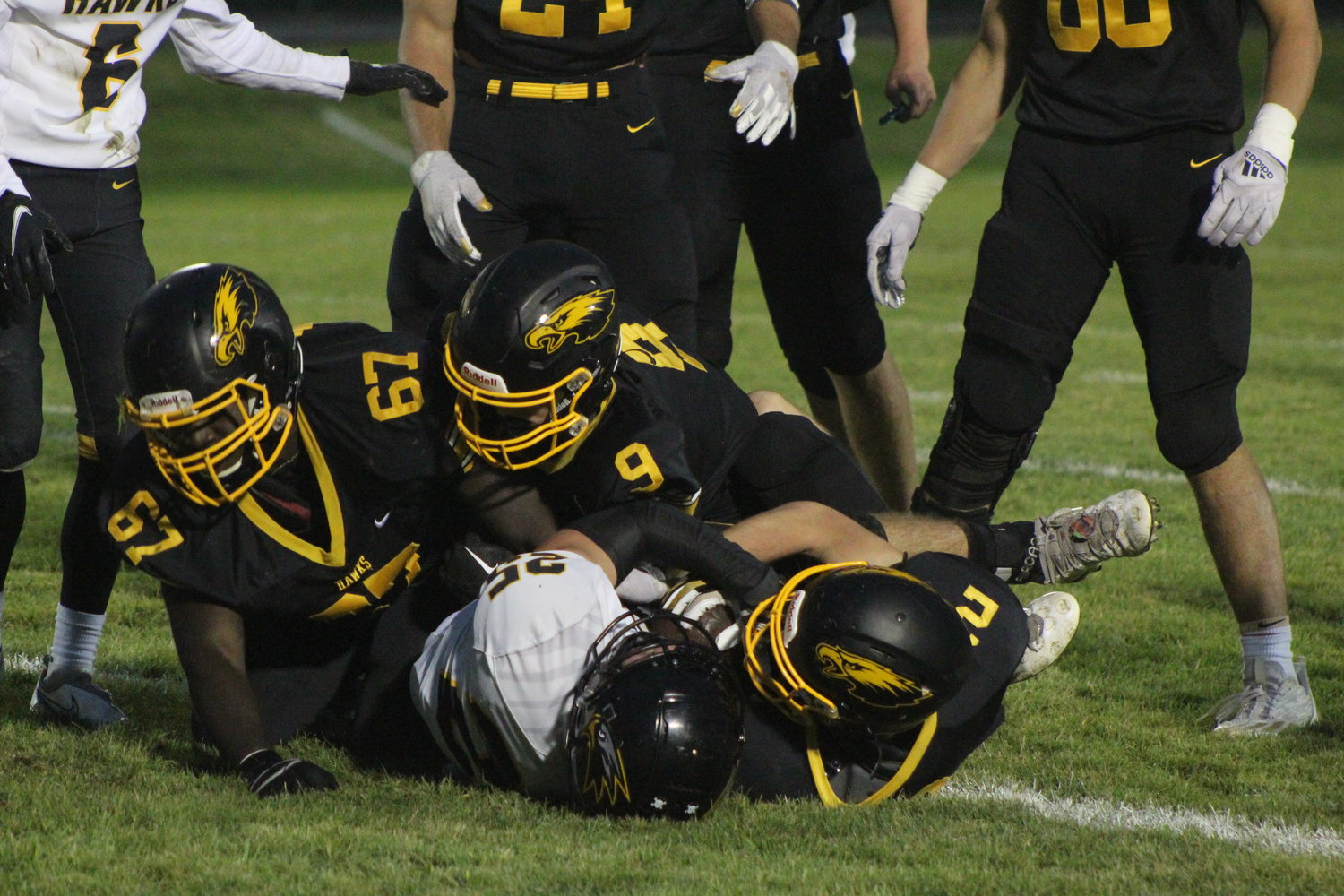 Mid-Prairie's Terry Bordenave, Cobi Hershberger and Cain Brown bury Central Lee's Chase Johnson.