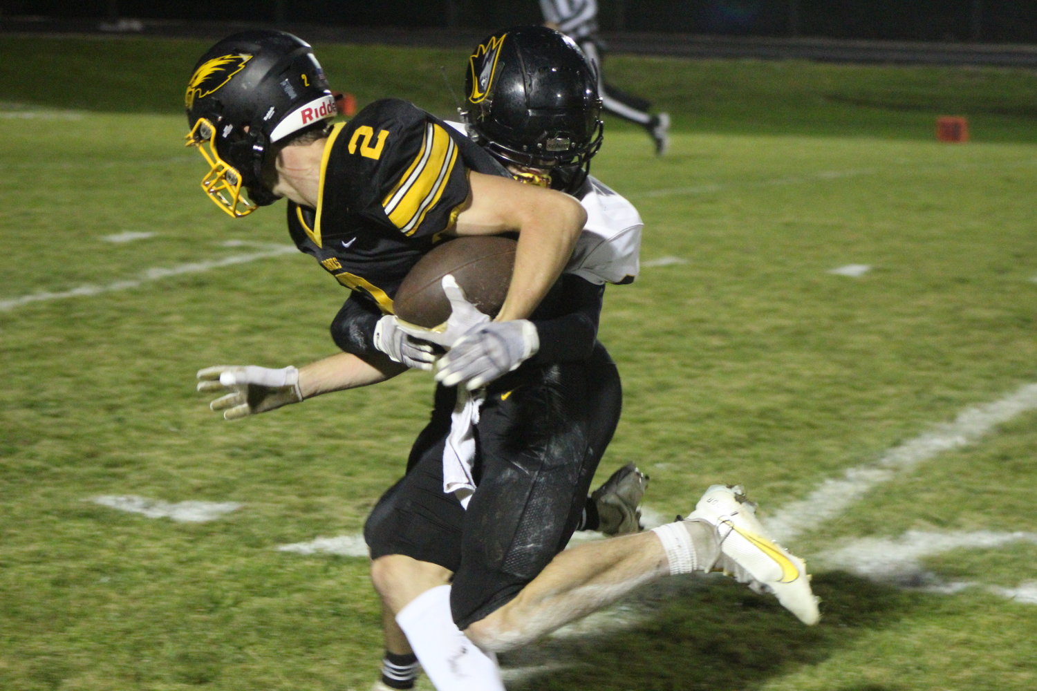 Mid-Prairie receiver Cain Brown tries to get around Central Lee's Grant Myhre after catching a pass from Collin Miller.