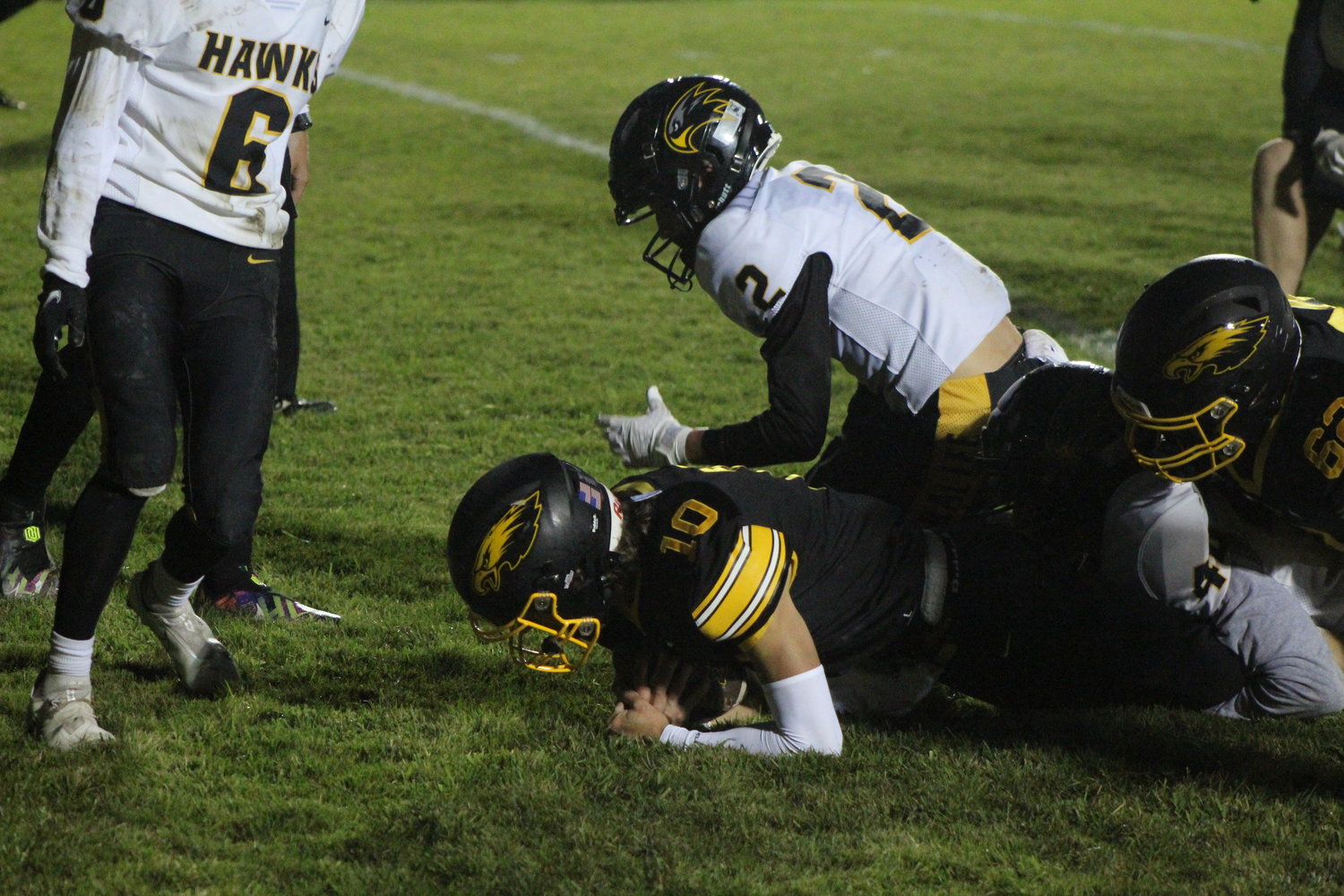 Mid-Prairie quarterback Collin Miller makes it into the end zone for one of his three touchdowns.