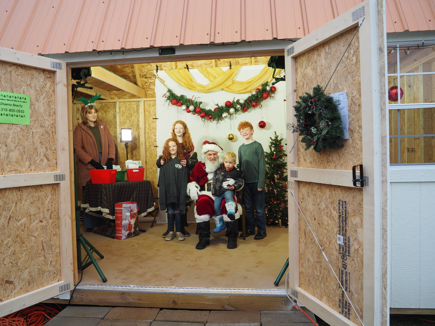 Kids enjoyed meeting Santa inside a shelter provided by Premier Portable Buildings, and every kid received a book from the Wellman-Scofield Public Library.  The library’s Carrie Geno also took photos that families can download free on the library’s website.