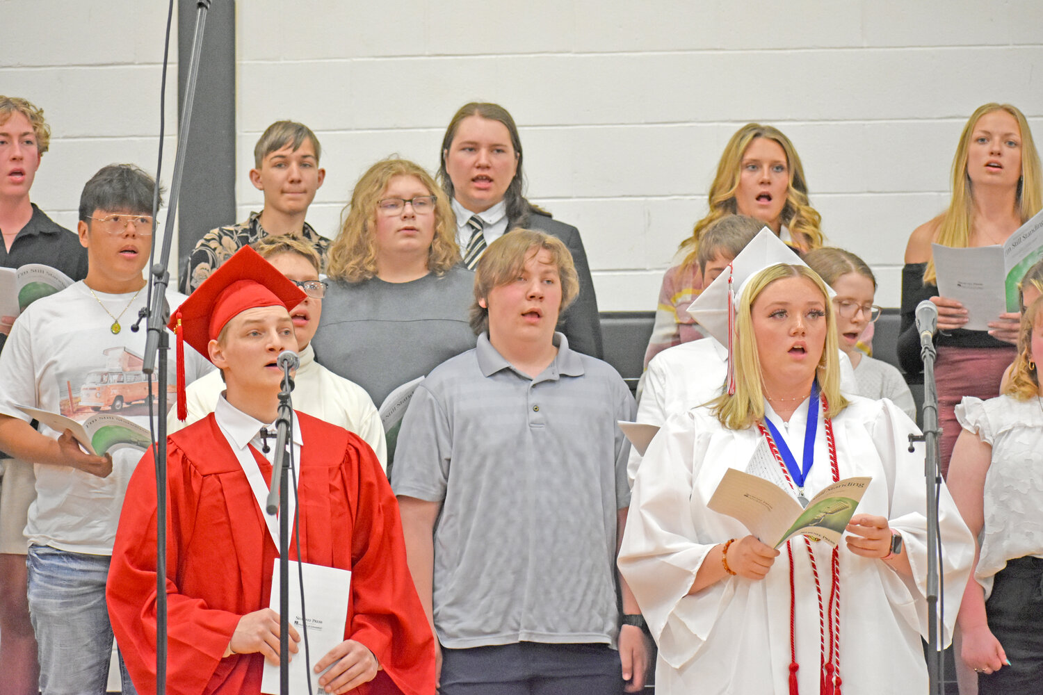 Seniors Ethan Krotz and Anna Herrig sing solos in “I’m Still Standing,” backed up by the high school choir.