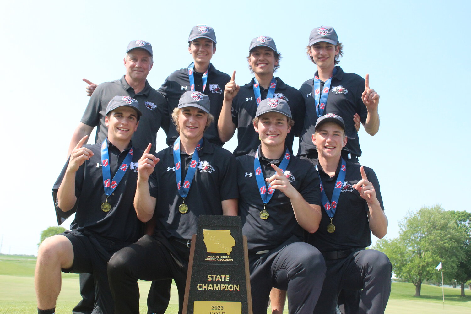 Hillcrest golfers celebrate winning the school's first state championship in golf, finishing off an unbeaten season.