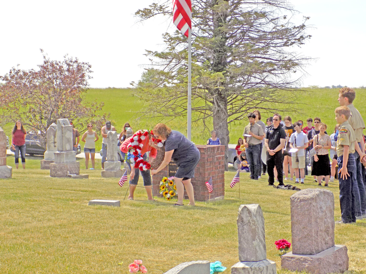 The AmVets Post 107 Ladies Auxiliary places a wreath in memory of service members lost in war during the Memorial Day ceremony at Richmond Catholic Cemetery.