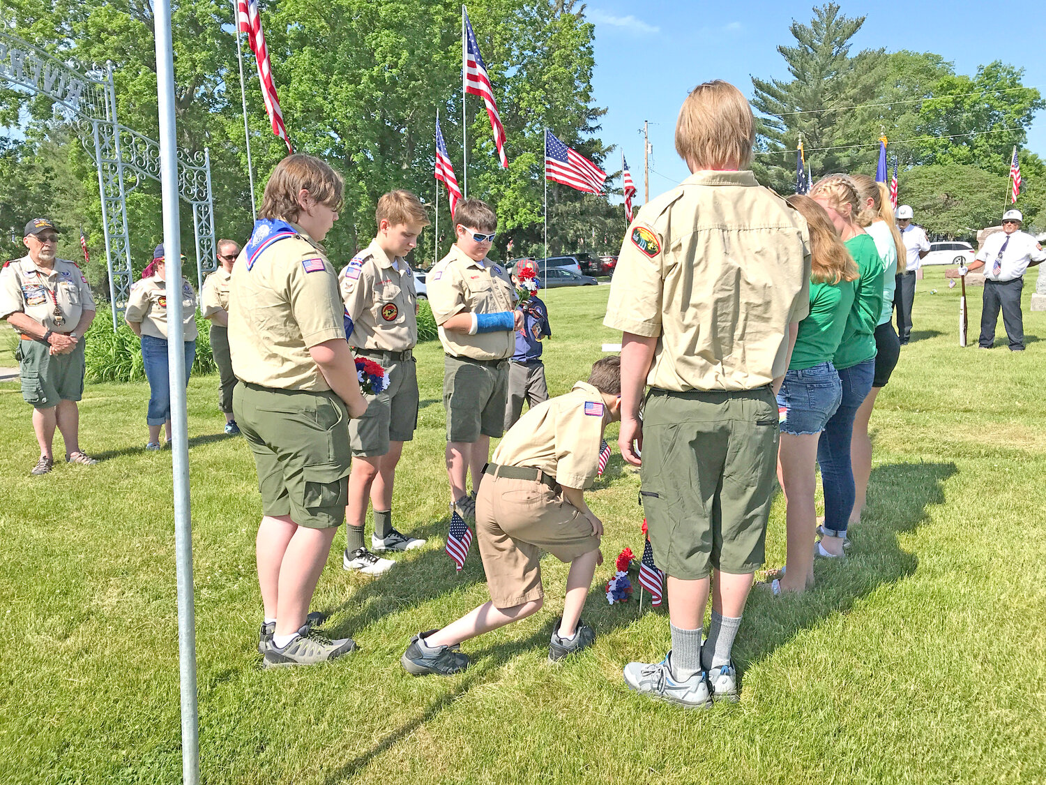 Girl Scouts and Boy Scout Troop 235 laying flowers in Riverside.